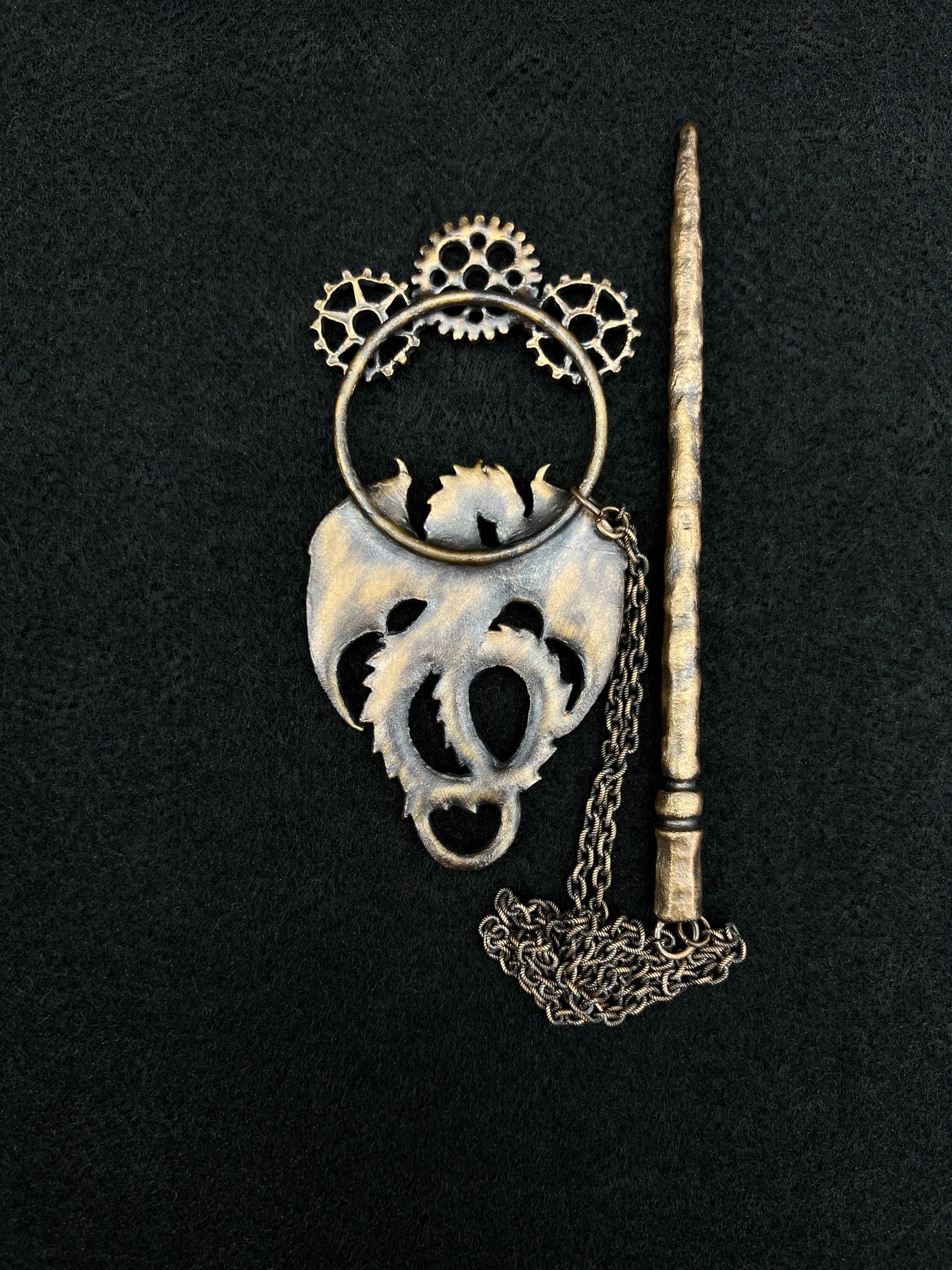 back side of copper hair clip with dragon and gears design